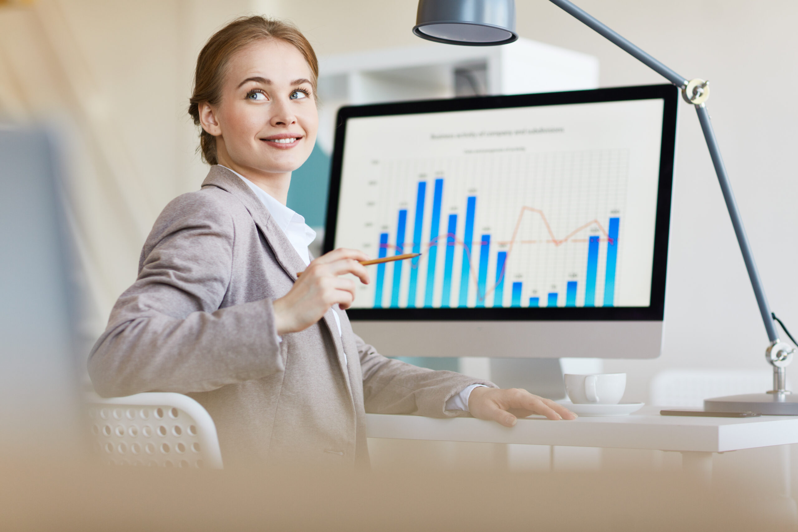 Young financier listening to colleague during discussion of data